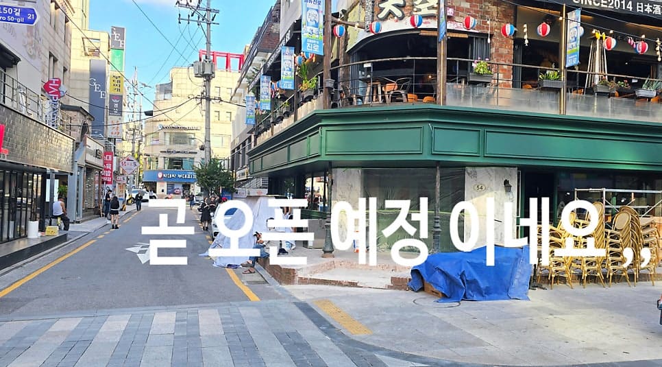 공사 중인 상가와, 이미 저녁 손님으로 채워진 옆 가게입니다. 문을 닫는 자리와 여는 자리가 같은 골목에 나란히 있습니다.