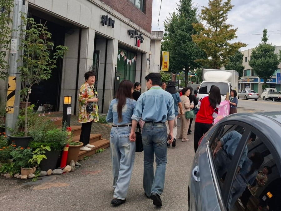 명주동이라는 이름을 그대로 간판에 새긴 건물. 강릉안길 골목투어 참가자들이 이 앞에 모여 설명을 듣는다. 이름 하나가 지역 해설의 소재가 될 만큼,