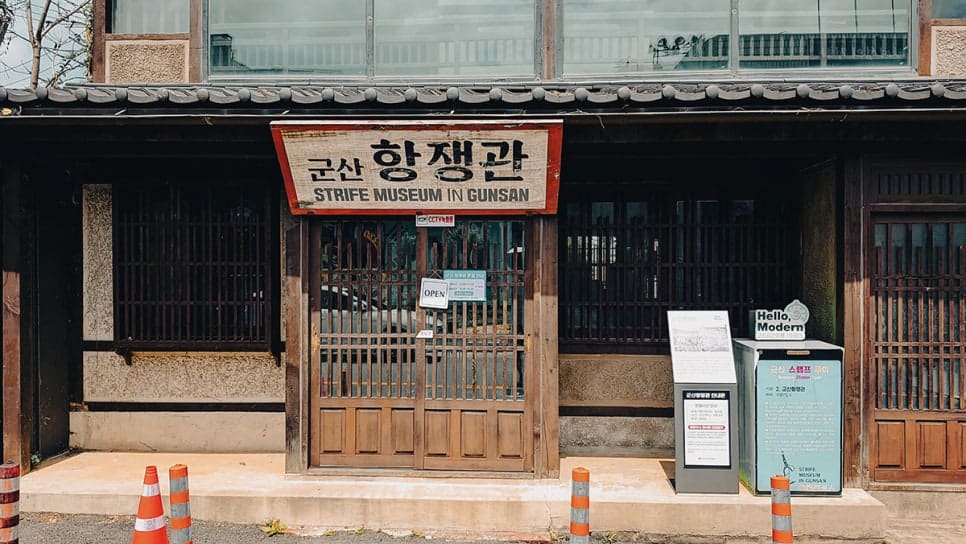 bakilhong66이 찍은 입구 간판과 2층 전시입니다. 한글과 영문을 나란히 새긴 간판 아래로 개방 안내판과 스탬프 투어 표지판이 서 있고,