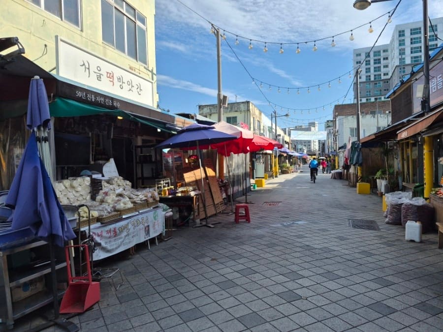 treeeast님이 이른 아침 시장을 찾아 남긴 사진입니다. 입구의 아치 조형물에는 1913이라는 숫자와 송정역시장이라는 글자가 큼직하게 걸려 있고,