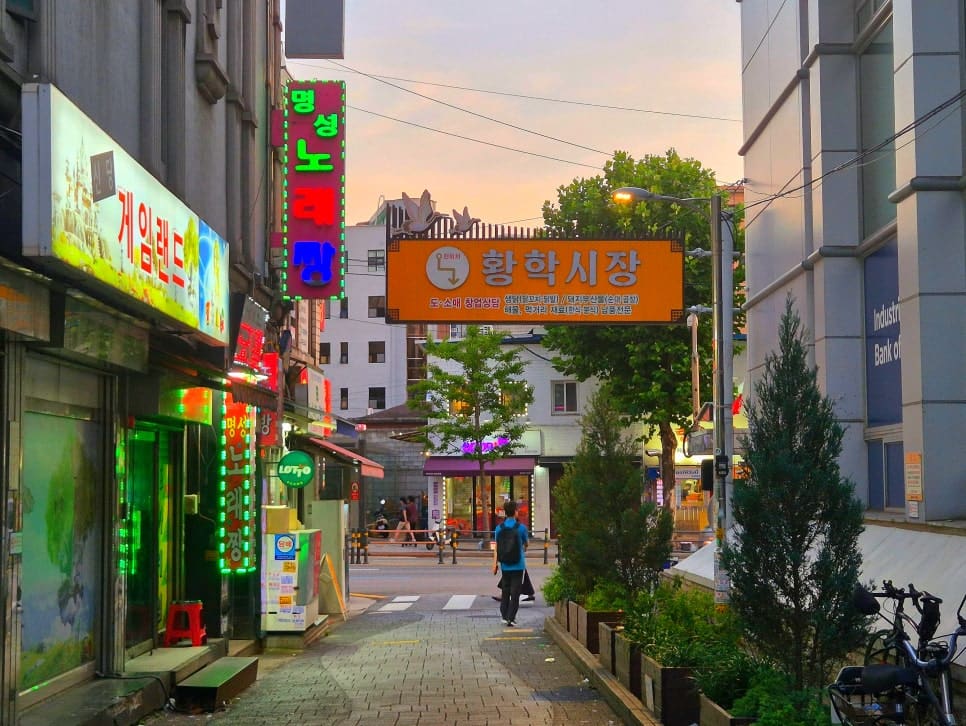 jhbluesss가 촬영한 황학시장 입구입니다. 오렌지색 간판 아래로 도소매와 창업 상담까지 적혀 있어 지금도 상권이 이어지고 있음을 보여줍니다.