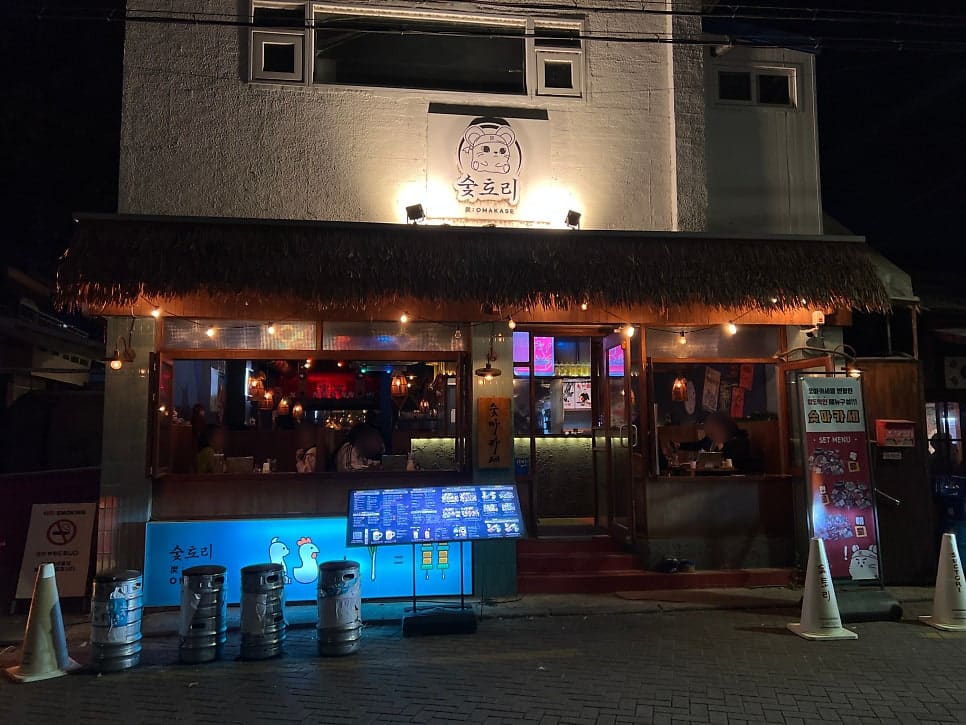 이자카야를 다녀간 방문자가 남긴 사진입니다. 저녁 시간, 칸막이 테이블마다 사람이 들어차 있고 조명마다 다른 색이 섞여 있습니다.