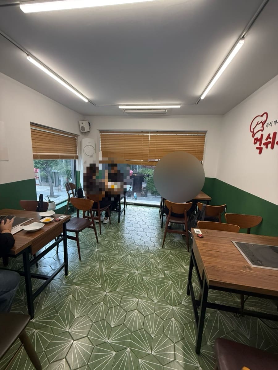 sirifood는 추억 속 먹쉬돈나가 정겨운 분식집 이미지였는데 삼청동점은 생각보다 넓고 쾌적한 공간이라 색다르게 다가왔다고 적었습니다. 사진에는 블라인드가 내려온 창가 자리와,