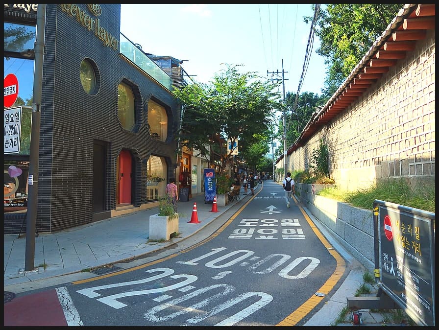 골목의 중앙을 가득 메운 현대식 건물이 오른쪽의 종묘 돌담과 나란히 선다. 이 대비가 서순라길의 변화를 압축해 보여준다. 규제가 풀렸을 때 개발의 물결이 여기까지 밀려왔지만,