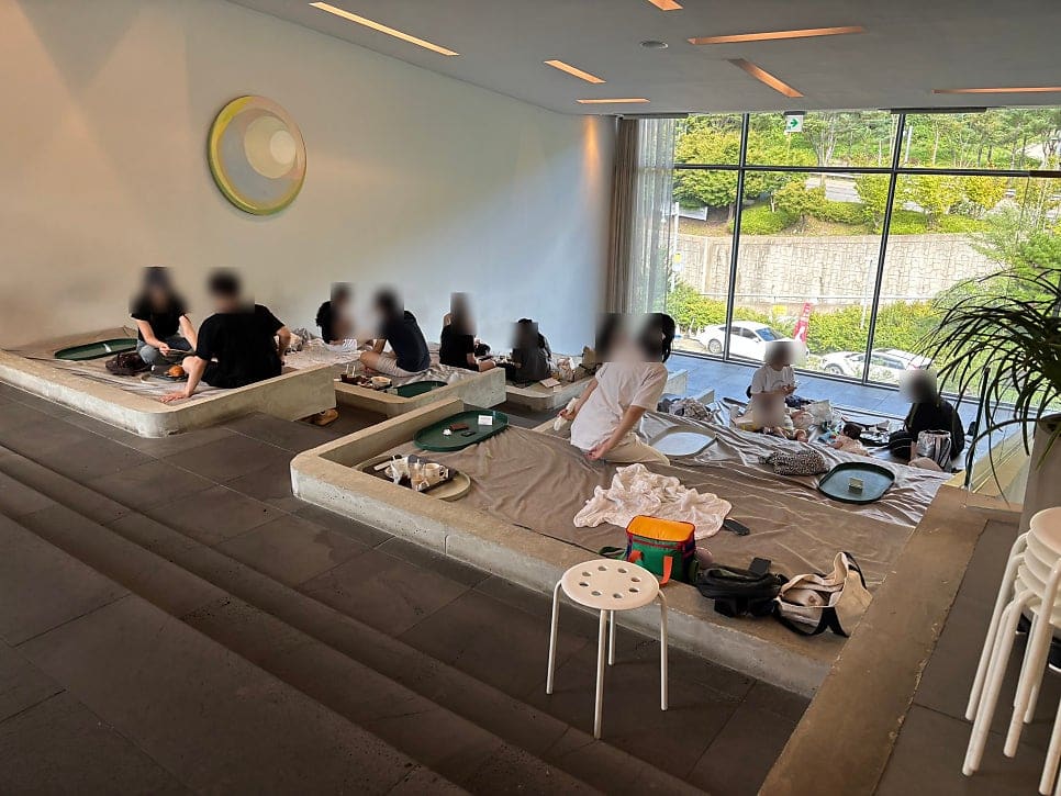 teamjiyu가 아기와 함께 둘러본 르디투어입니다. 유리 난간 계단으로 층과 층이 이어지는 모습과, 2층과 3층 사이 넓은 평상 좌석에 자리 잡은 손님들을 담았습니다.
