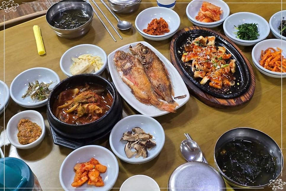 soheemom0212이 남긴 사진입니다. 생선구이와 고등어조림, 열 가지 반찬이 놓인 상 전체와 불판 위 양념장어를 담았는데,